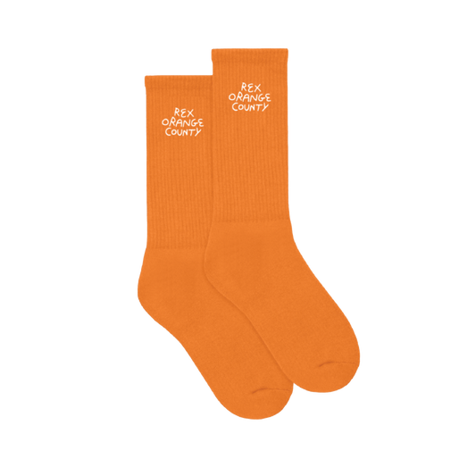Side view of orange socks featuring white Rex Orange County text printed at the top of each sock.