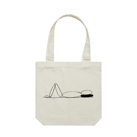 Front view of an ecru tote bag featuring a minimalist line drawing of a reclining figure.
