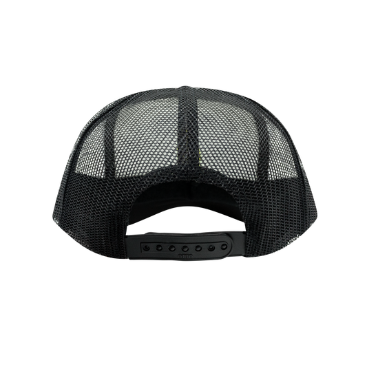 Back view of the black and white 5-panel trucker hat showing the mesh panels and adjustable strap.