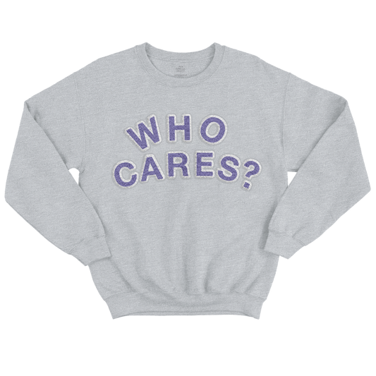 Front view of a grey unisex crewneck with purple chenille patches spelling out ‘WHO CARES?’. Product image is a digital rendering for illustration; actual details may vary.