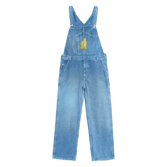 Front view of Dickies indigo overalls in stonewashed denim, featuring a yellow thumbs-up embroidery on the front chest pocket, a dual tool pocket on the right leg, a hammer loop on the left leg.
